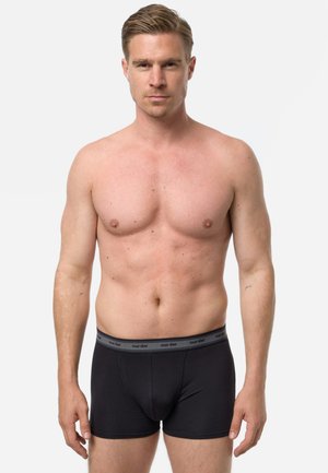 Sorte bokserbriefs med en strækbar grå linning med teksten "nur der". Stoffet er glat, og pasformen sidder tæt til kroppen.