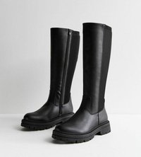 Botas negras hasta la rodilla con un acabado de cuero suave, cremalleras laterales y suelas de goma texturizadas, que cuentan con paneles elásticos para un ajuste ceñido.