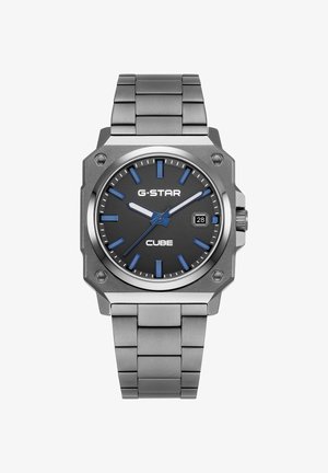 Firkantet sølv farvet metal armbåndsur med sort urskive, blå timemarkører, hvide og blå visere, datovindue ved tre-tiden og metal lænke.