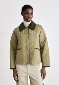 Olive green quilted jacket with a dark green collar, gold buttons, and two front pockets. Features a diamond pattern and brand logo.