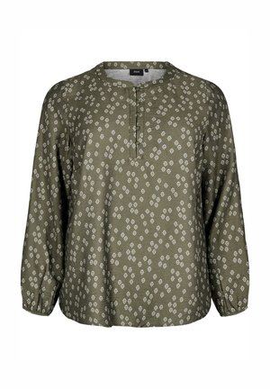 Zelena bluzica s vzorcem, okroglim izrezom, gumbasto zapenjanje in dolgimi rokavi. Ima beli elipsasti print po celotni površini.