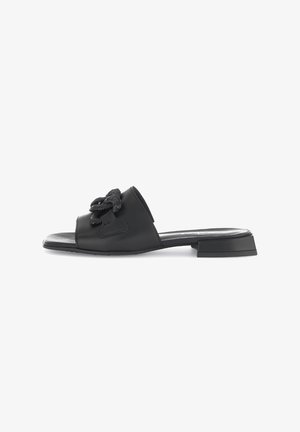 Black leather slide sandal featuring a square toe, a low block heel, and a textured floral detail on the upper. Smooth finish throughout.