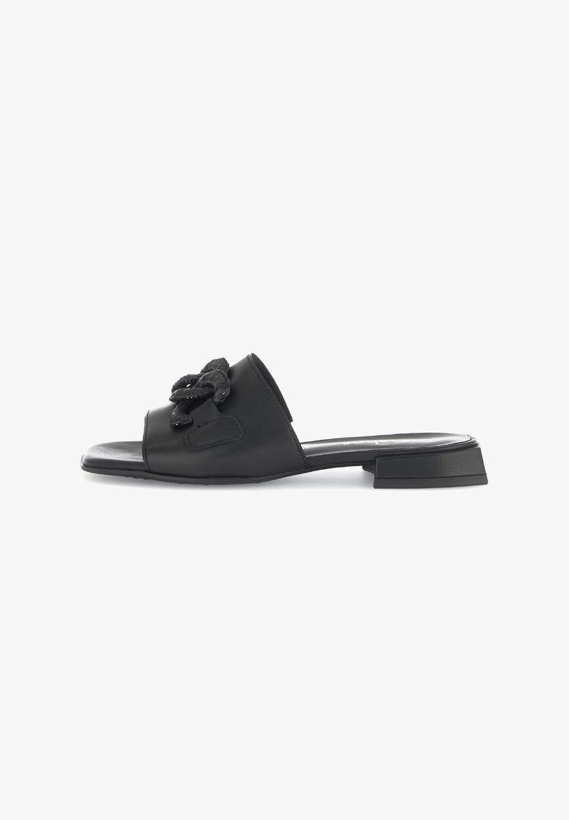 Black leather slide sandal featuring a square toe, a low block heel, and a textured floral detail on the upper. Smooth finish throughout.