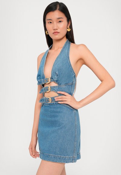 Denim mini dress with a plunging neckline, three gold buckle accents, and a fitted silhouette. The fabric has a smooth texture and light blue color.