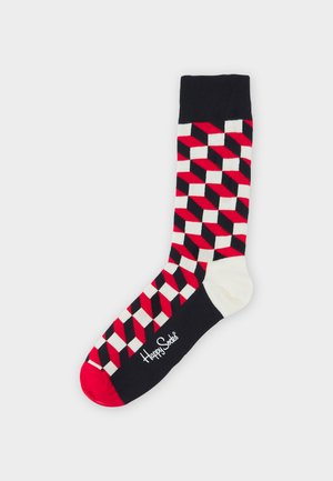 Colorful socks with a geometric pattern in red, black, and white. Features a solid black cuff and a white toe. Logo printed on the side.