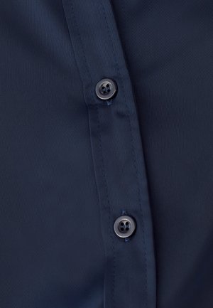 Navy blue shirt fabric with a smooth texture, featuring two dark buttons along the placket, showcasing a classic button-up design.