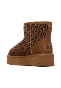 Braune Wildleder-Ankle-Boots mit Leopardenmuster, ausgestattet mit einer flachen Plattformsohle und einem Markenpatch auf der Rückseite. Texturiertes Obermaterial und gestickte Nähte.