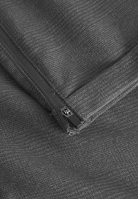 Dark gray textured fabric features a side zipper with a black pull tab. The material has a subtle pattern, adding dimension.