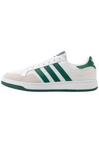 White sneaker with green accents, featuring three green stripes, textured fabric upper, suede toe cap, and a rubber sole.