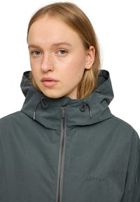Dark gray waterproof jacket featuring a hood, adjustable drawstrings, and a front zip closure. Embroidered "MAZINE" logo on the chest.
