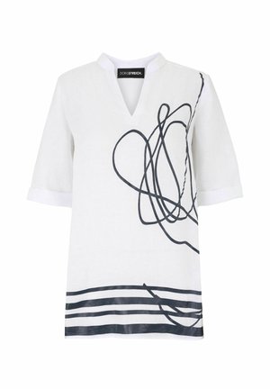 White short-sleeve V-neck shirt with black abstract squiggle design on right side and horizontal stripes at bottom hem.