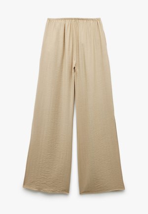 Beige vide ben bukser med elastisk talje og et let tekstureret stof, præsenteret fladt på en hvid baggrund.