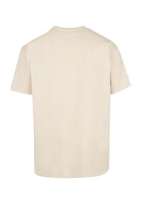Short-sleeve T-shirt in light beige cotton fabric. Features a crew neck and a relaxed fit, with a smooth, even texture throughout.