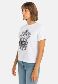 White cotton t-shirt with short sleeves featuring a black graphic design of vases holding roses. Boxy fit, crew neck, and simple stitching.