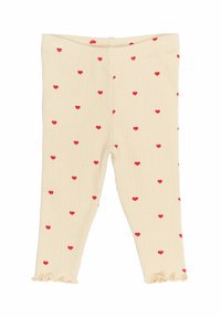 Ráncos leggings krém színben, szórt piros szív mintákkal; a bokáknál fodros szegőkkel.