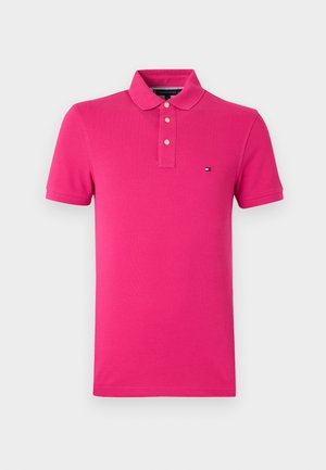Pink polo shirt made of smooth cotton, featuring a traditional collar, three-button placket, and a small logo detail on the chest.