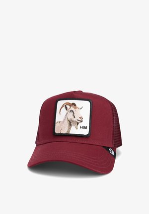 Red baseball cap featuring a square patch with an embroidered goat and the text "HIM." The cap has a solid front and mesh back.