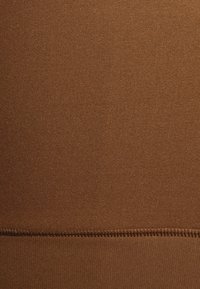 Brown fabric featuring a smooth, even texture with a horizontal seam at the bottom. Material appears stretchy and lightweight.