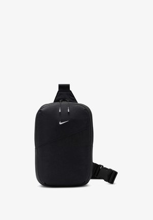 Bolsa bandolera Nike compacta de color negro con compartimento principal con cremallera y correa ajustable con hebilla, diseñada para uso casual o deportivo.