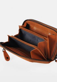 Brown leather wallet with a zip closure, multiple card slots, and a textured interior in navy, offering organized storage and durability.
