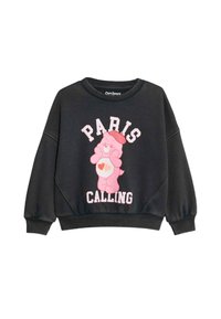 Czarny sweter z okrągłym dekoltem, z grafiką różowego misia Care oraz napisem "PARIS CALLING" w białym i różowym kolorze. Ribbed cuffs and hem.
