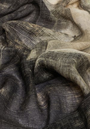 Linen scarf with a textured weave, featuring a gradient pattern of black, gray, and cream colors, showing soft, flowing fabric drapes.