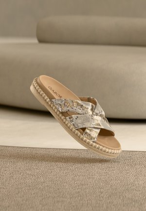 Beige and gold braided slide sandal with cross straps, textured synthetic material, flat sole, and cushioned insole. Brand logo inside.