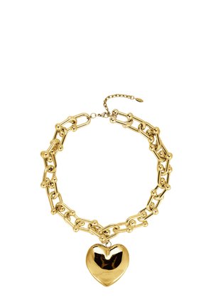 Gold chain necklace with spherical accents and a large, shiny heart-shaped pendant on a white background.