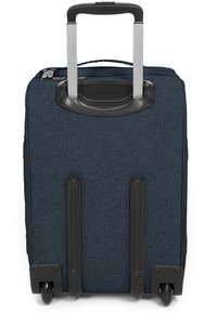 Dark blue fabric suitcase with a retractable handle, black accents, smooth wheels, and horizontal zipper detail at the top.