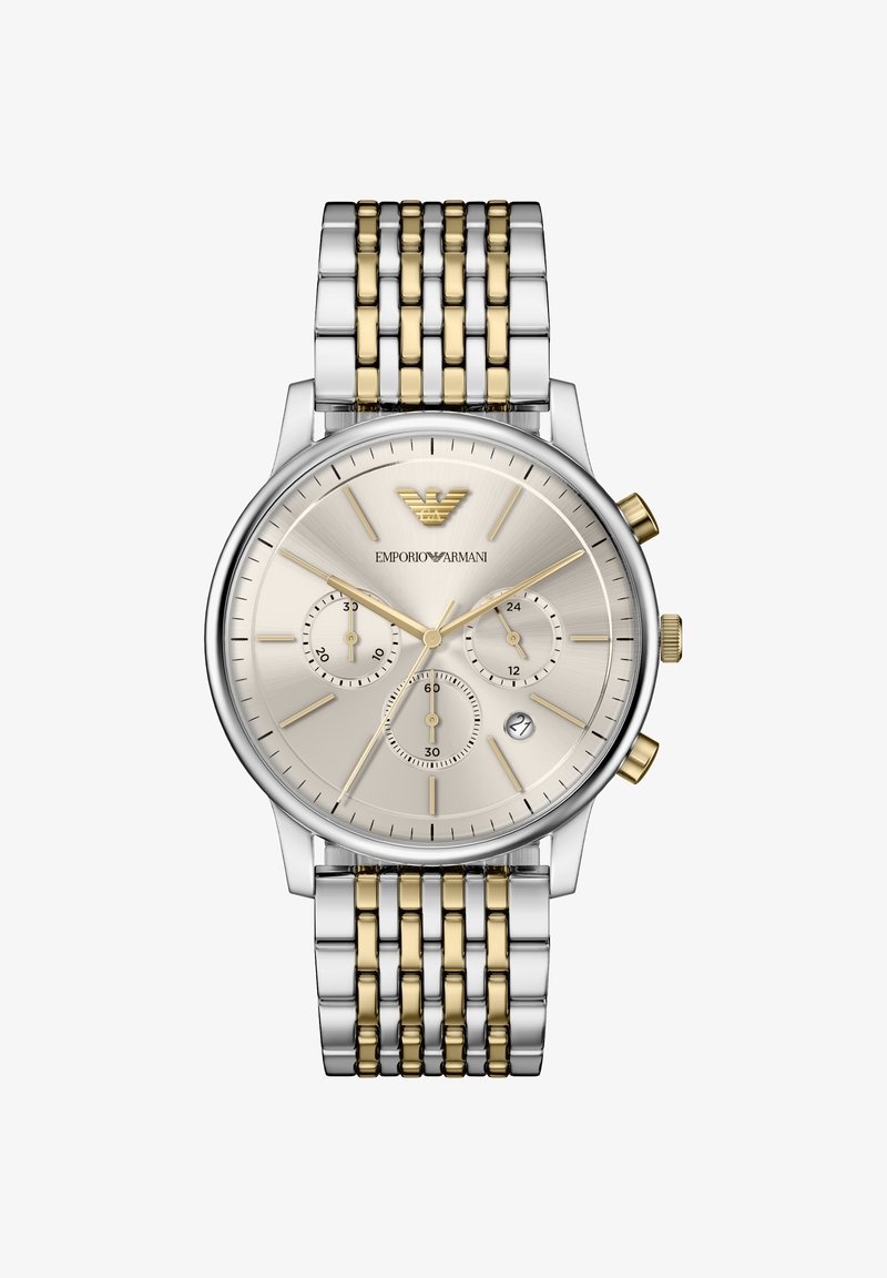 Silberne und goldene Edelstahluhr mit rundem, beigem Zifferblatt, drei Hilfszifferblättern und strukturierter Oberfläche. Oben befindet sich ein Adler-Logo.