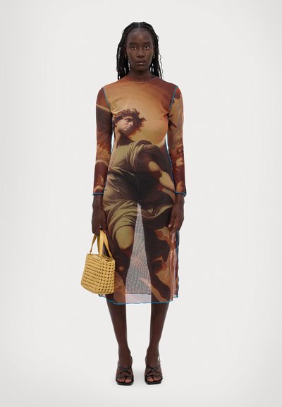 Long-sleeve dress with a sheer, printed fabric featuring a classical art design in warm tones, outlined in blue. Paired with a woven yellow bag.