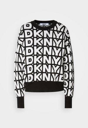 Juodas ir baltas megztinis su kartotiniais "DKNY" logotipų raštais, apvalia kaklo iškirpte ir ilgomis rankovėmis su įsiūtomis rankogaliais ir apatine dalimi.