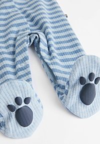 Blue and white striped fabric footed onesie with rounded paws at the feet featuring black paw print accents. Soft textile texture.