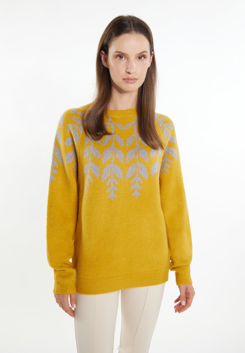 Maglione giallo lavorato a maglia con una vestibilità ampia, caratterizzato da un motivo a foglia in grigio chiaro. Polsini e orlo a costine, texture morbida.