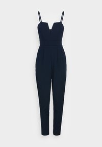Marininspirerad jumpsuit med justerbara spagettiband, djup V-ringning, figursydd midja och tapered ben. Tillverkad av ett smooth tyg med veckade detaljer.