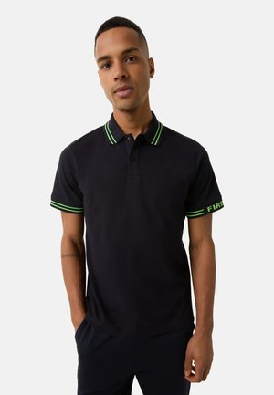 Short-sleeve polo shirt in navy cotton with green striped collar and sleeve details. Features embroidered logo on the chest.