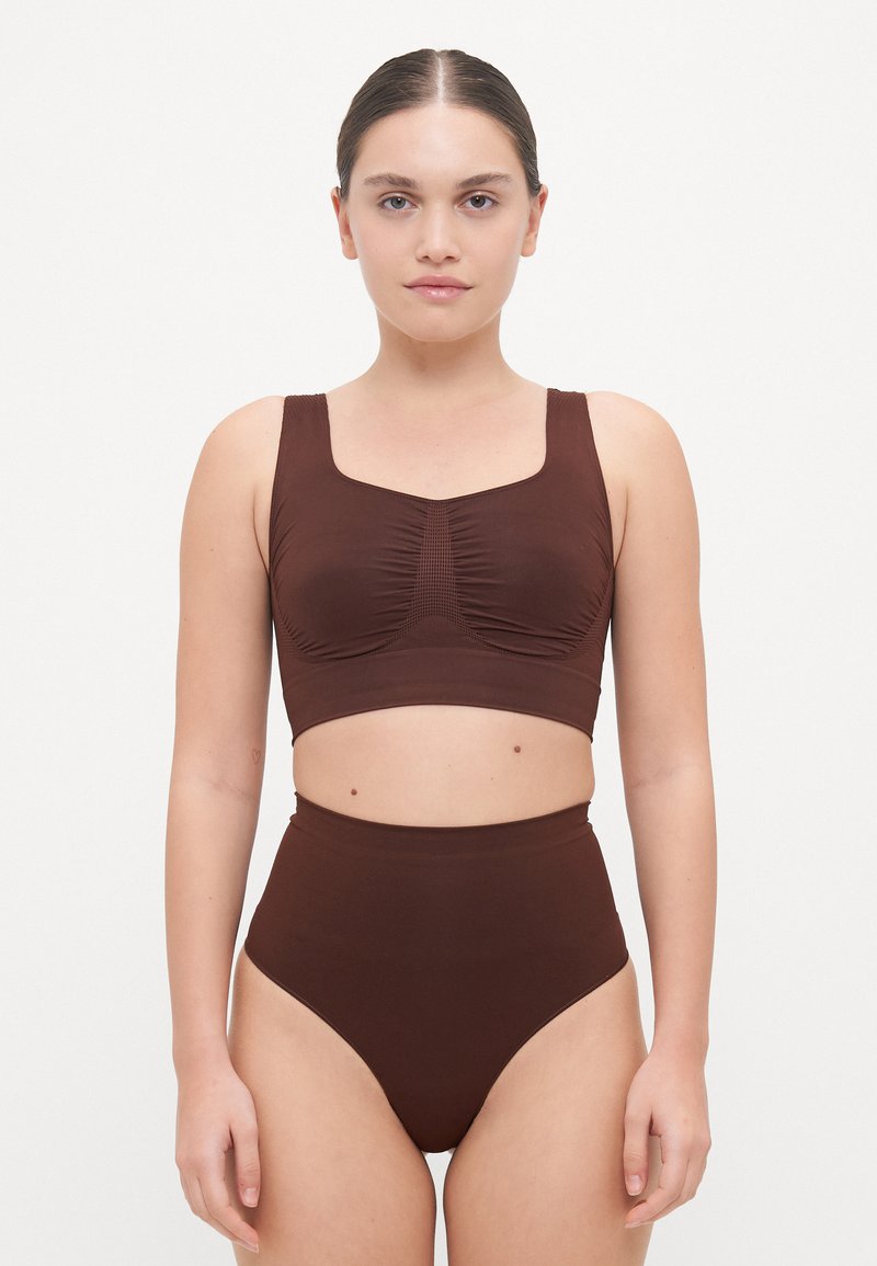 Brown two-piece swimwear set featuring a sleeveless, fitted top with ruching and high-waisted bottoms, made from smooth, stretchy fabric.