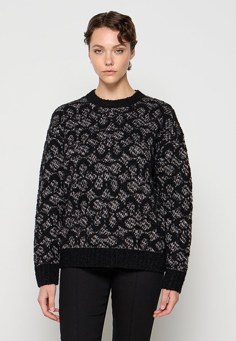 Zwarte trui met een textuurpatroon in lichte tinten, ronde halslijn, lange mouwen en een iets losse pasvorm. Het materiaal lijkt zacht te zijn.