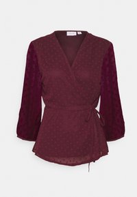 Blusa avvolgente bordeaux con motivo a pois, maniche lunghe trasparenti e cintura in vita. Tessuto morbido con una texture liscia. Collo a V.