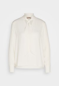 Bílá halenka s dlouhým rukávem, uvázaným límcem a výřezem. Hladký materiál, volný střih, manžety na zápěstích. Čistý design bez ozdob.