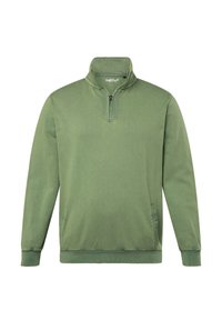 Grön sweatshirt med halv dragkedja, ribbade ärmslut och sidofickor. Tillverkad av mjukt tyg med en texturerad yta.