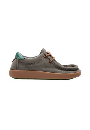 Zapato informal de ante gris con suela marrón, lengüeta verde en el talón y cordones marrones, visto de perfil sobre fondo blanco.