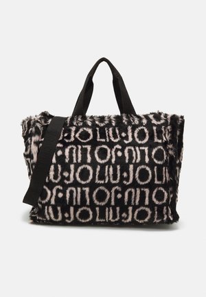 Black and beige furry tote bag with repeated "LIU JO" logo pattern, dual handles, and an adjustable shoulder strap.