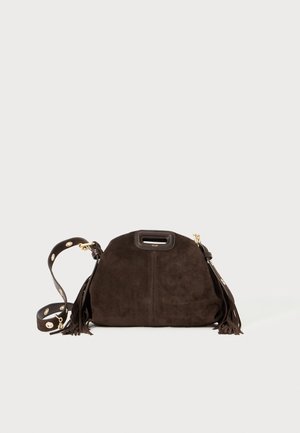 Brown suede handbag with a rounded shape, decorative fringes, detachable strap featuring gold hardware, and a top handle.