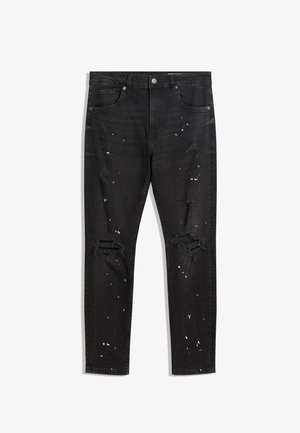 Jean skinny noir délavé avec éclaboussures de peinture et détails déchirés sur les cuisses et les genoux à l'avant, poches avant et fermeture à boutons.