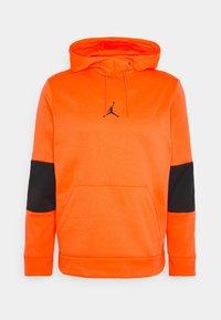 Felpa arancione con cappuccio, dotata di tasca a marsupio, accenti neri sulle maniche e logo Jumpman nero sul petto. Tessuto morbido.