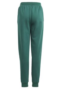 Pantalones de chándal verdes de algodón con un corte relajado, cinturilla elástica y tobillos ajustados. Textura suave, color sólido, sin patrones o herrajes visibles.