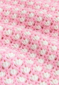 Crochet fabric in alternating rows of light pink and white. Soft texture with a loose weave, creating a pattern of rounded shapes.