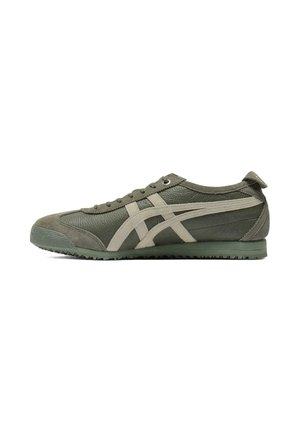 Green athletic shoes made of leather and suede, featuring a textured upper, pale accents, round toe, and a textured rubber sole.