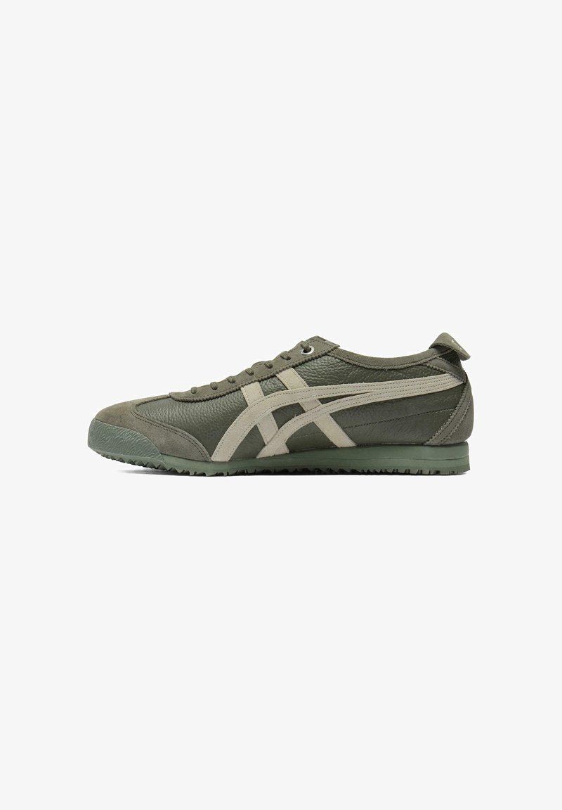 Green athletic shoes made of leather and suede, featuring a textured upper, pale accents, round toe, and a textured rubber sole.